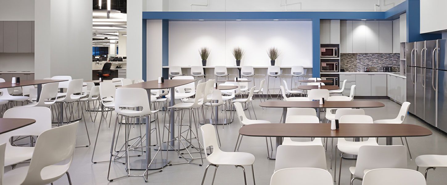 Break room with tables and chairs in an office building