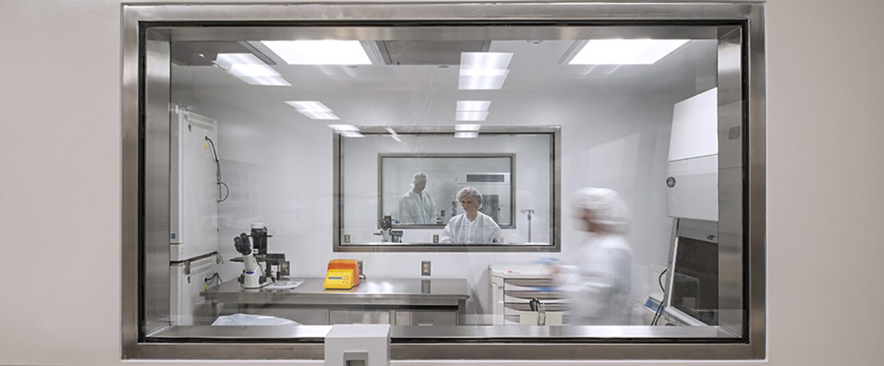 Lab technicians working in a cell therapy lab.
