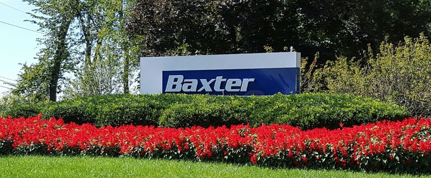 Baxter exterior sign with red flowers.