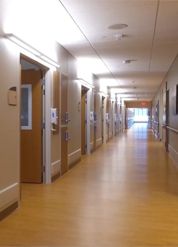 Hospital hallway with many doors.